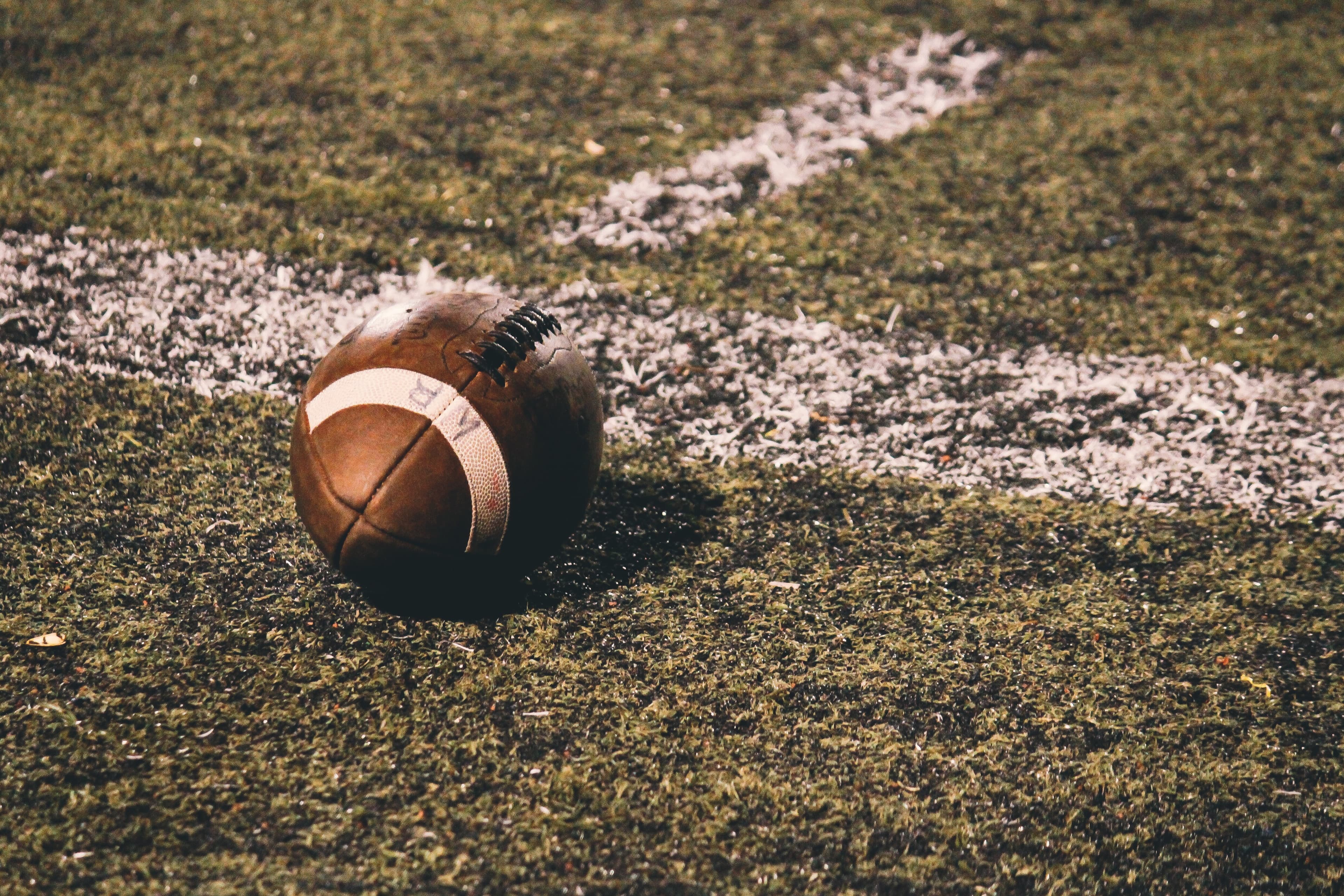 A football resting on the field